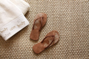 920060 flip flops with towels on seagrass rug