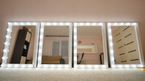 Four make up mirrors stand in the room and are lit. Mirrors turn on in turn.